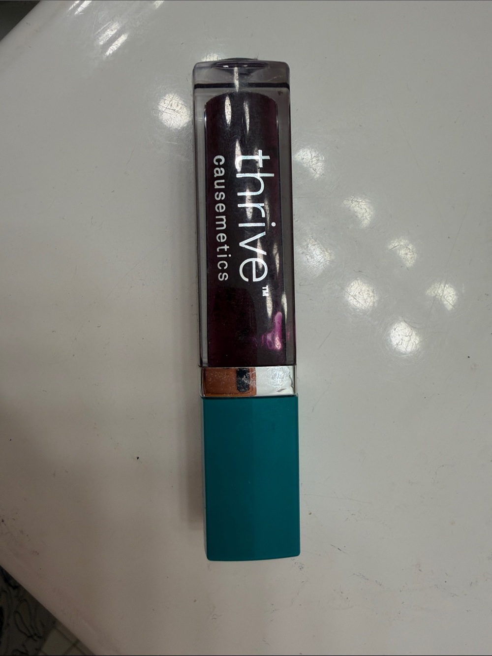 Thrive Causemetics Liquid Lipstick in Plum with Teal Cap